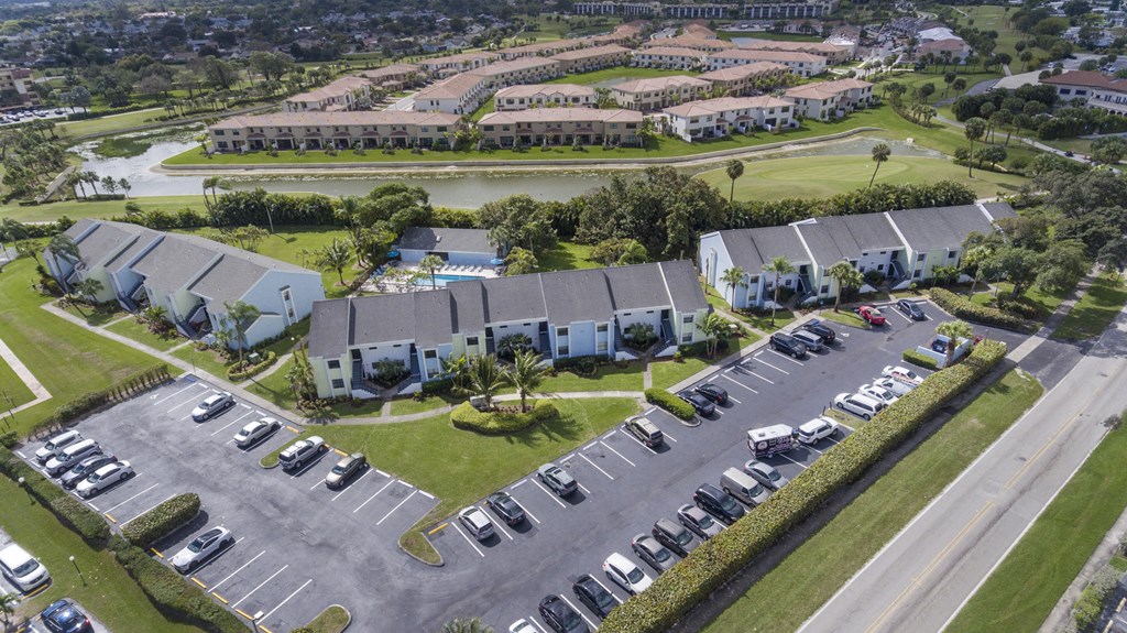 A parking lot with cars and a building in the background.